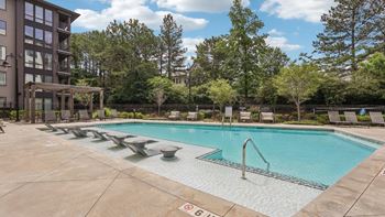 Resort style pool with sun deck & grill picnic area